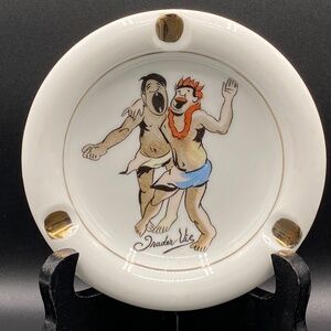 Trader Vic's Tiki ceramic ashtray, with two happy islanders, gold trim.